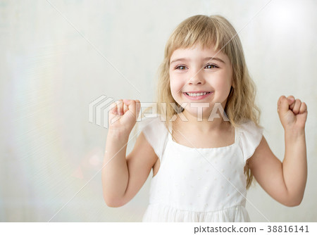 Portrait of pretty little girl in white dress. 38816141