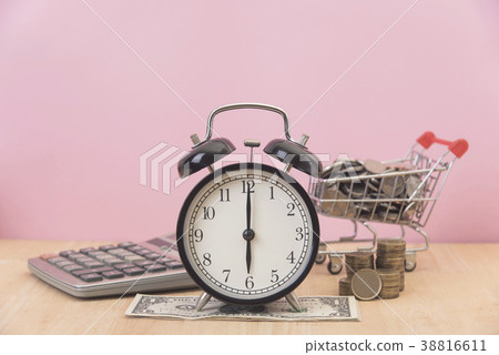time is money. alarm and dollar, coin on table. time is money. alarm and dollar, coin on table. 38816611