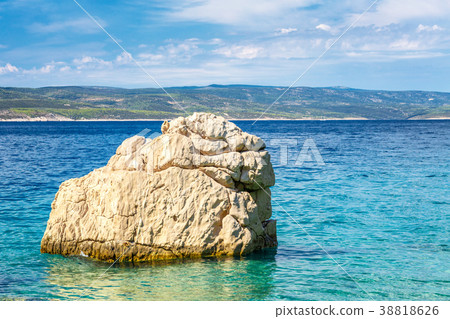 Rock in the sea at the beach in Baska Voda Rock in the sea at the beach in Baska Voda 38818626