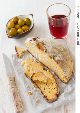 corn bread with olives and red wine on paper corn bread with olives and red wine on paper 38820072