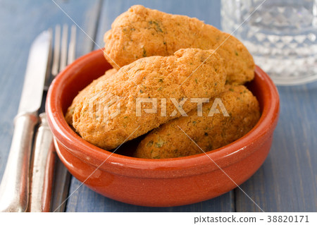 fish croquettes on dish on blue background 38820171