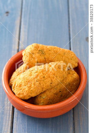 fish croquettes on dish on blue background 38820173