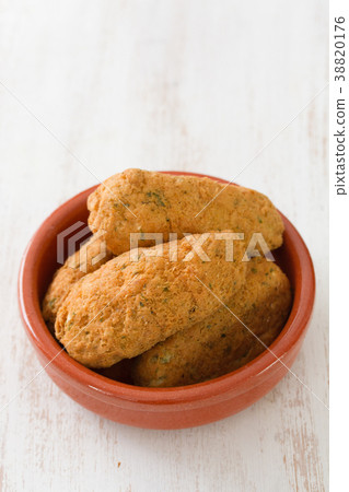 cod fish croquettes on dish on white background 38820176