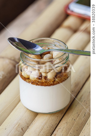 Glass jar with delicious yogurt Glass jar with delicious yogurt 38820339