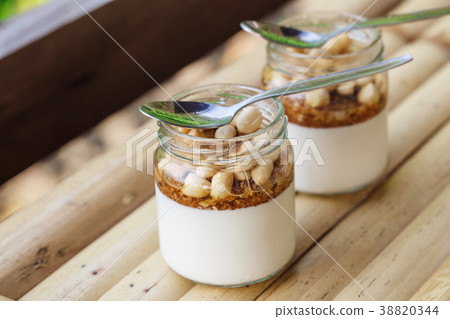 Glass jars with delicious yogurt Glass jars with delicious yogurt 38820344