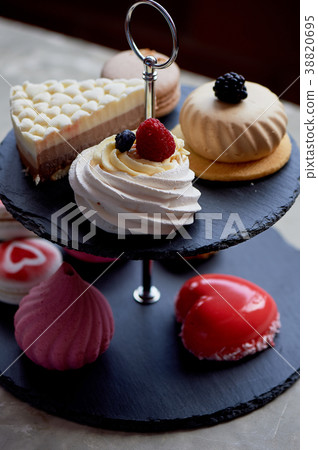 Cakes on a dark slate bunk stand.Desserts. Sweet 38820695