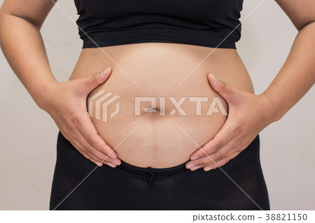 women body fat belly front view and hand squeezing 38821150