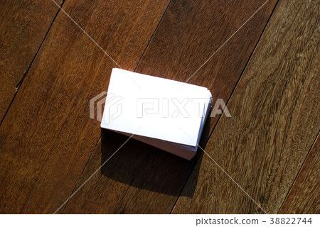 White business cards laid on a wooden floor. White business cards laid on a wooden floor. 38822744