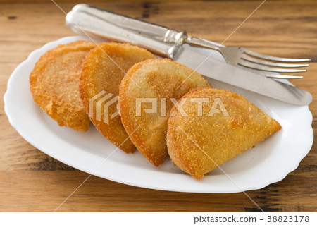 meat cookies on white dish on brown background 38823178