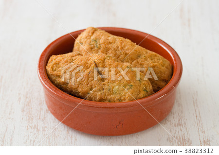 cod fish croquettes on dish on white background 38823312