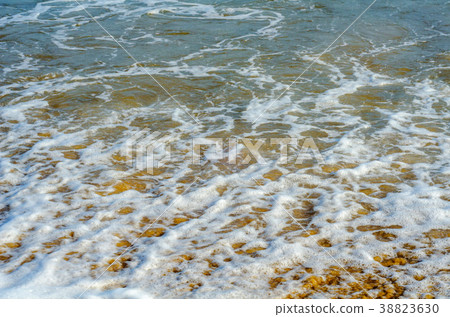 sea waves affecting the sandy beach 38823630