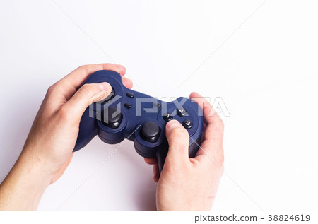 A young guy holds a joystick and plays games A young guy holds a joystick and plays games 38824619