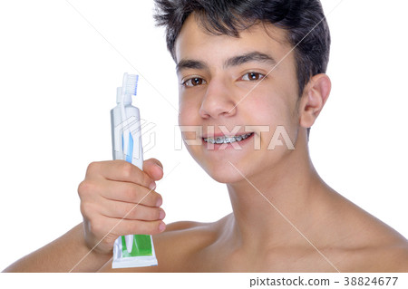 Teen boy wearing braces on white background 38824677