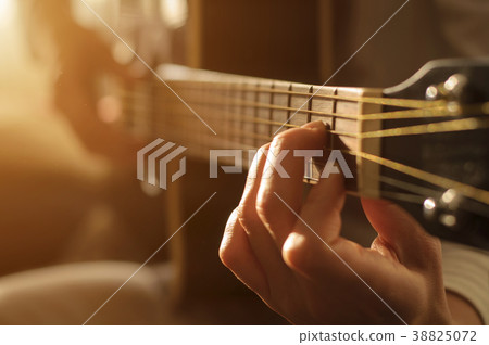 playing acoustic guitar 38825072