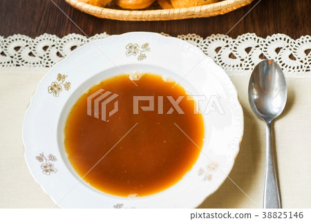Pure beef broth in plate in table. Pure beef broth in plate in table. 38825146