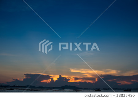 Nice sun ray in twilight sky at sea with island 38825450