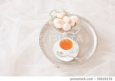silver tray with cup of tea and macaroons top view 38826238