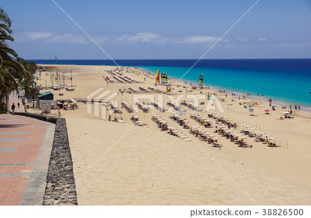 Sand dune and coastal promenade along a beach in 38826500