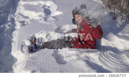 Beautiful teenage girl playing with snow in winter 38826737