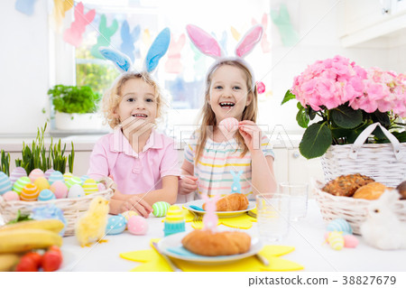 Easter egg hunt. Kids with bunny ears and basket. 38827679