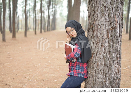 Portrait of young muslim woman scottish shirt. 38831039