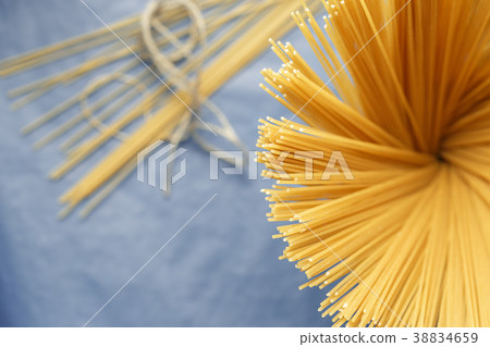 Uncooked pasta spaghetti on a purple background 38834659