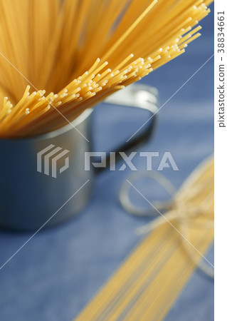 Uncooked pasta spaghetti on a purple background Uncooked pasta spaghetti on a purple background 38834661