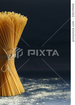 Uncooked pasta spaghetti on a blue background 38834666