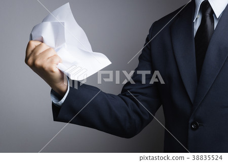Business man hand crunching a paper in anger 38835524