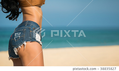 Close up sexy woman ass with jeans on the beach Close up sexy woman ass with jeans on the beach 38835827