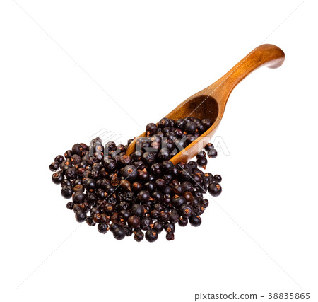 Dried Juniper berries on the wooden spoon. Dried Juniper berries on the wooden spoon. 38835865