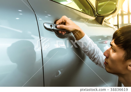 Asian man opens car Asian man opens car 38836619