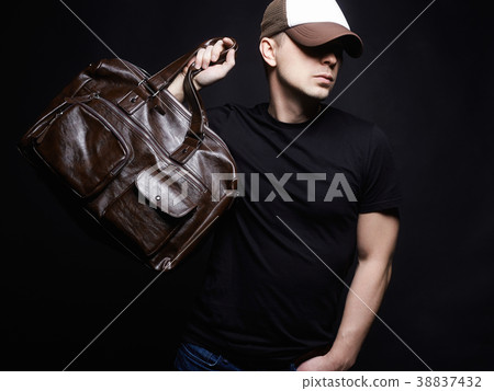 Portrait of a young man with handbag Portrait of a young man with handbag 38837432
