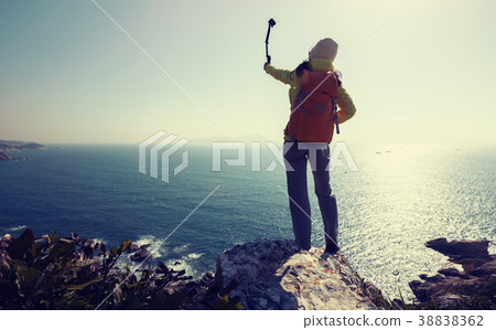 using action camera taking selfie at seaside 38838362