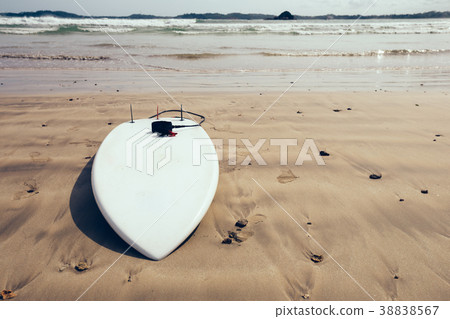 White Surfboard with leg leash on beach 38838567