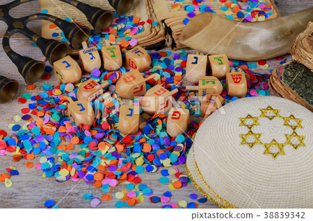 Chanukah wooden dreidels on a wood surface. Chanukah wooden dreidels on a wood surface. 38839342