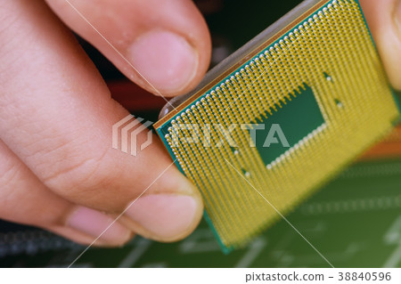 technician installing CPU into motherboard. technician installing CPU into motherboard. 38840596