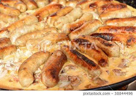 Fried sausages with mushrooms in a large frying Fried sausages with mushrooms in a large frying 38844496