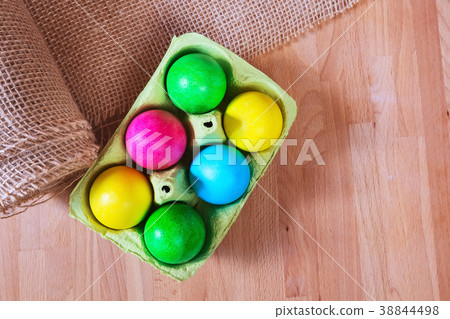 Colored Easter eggs in egg carton holder Colored Easter eggs in egg carton holder 38844498
