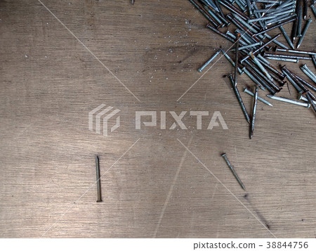 Rusty nails are randomly scattered over ply wood Rusty nails are randomly scattered over ply wood 38844756