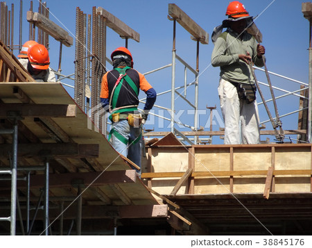 Construction workers fabricated timber form work 38845176