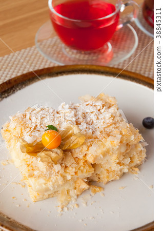 Napoleon cake on a white plate with berries with Napoleon cake on a white plate with berries with 38845311