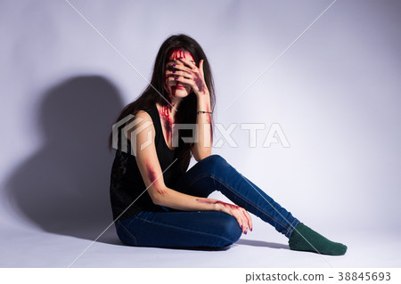Rape battered bloody victim sad woman sits on the 38845693