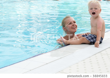 Mother and son have fun by a swimming pool Mother and son have fun by a swimming pool 38845833