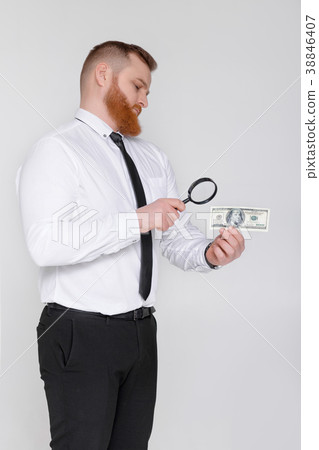 expert looking at magnifying glass for bill expert looking at magnifying glass for bill 38846407