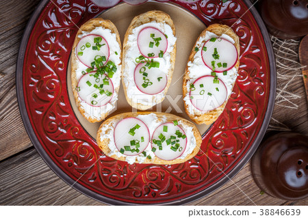 Toasts with radish, chives and cottage cheese. Toasts with radish, chives and cottage cheese. 38846639