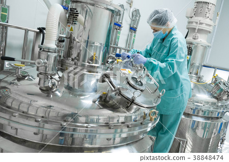 Pharmaceutical factory woman worker in protective 38848474