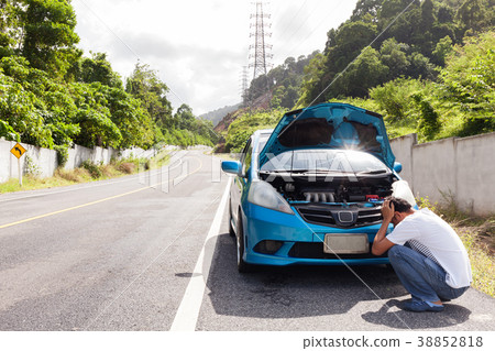 Man sitting on the road engine malfunction car 38852818