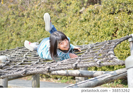 Girls playing with park play equipment 38853262