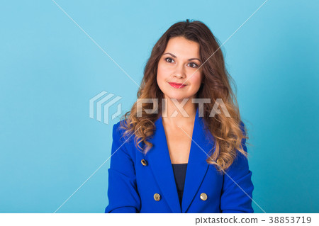 Smiling young business woman portrait on blue 38853719